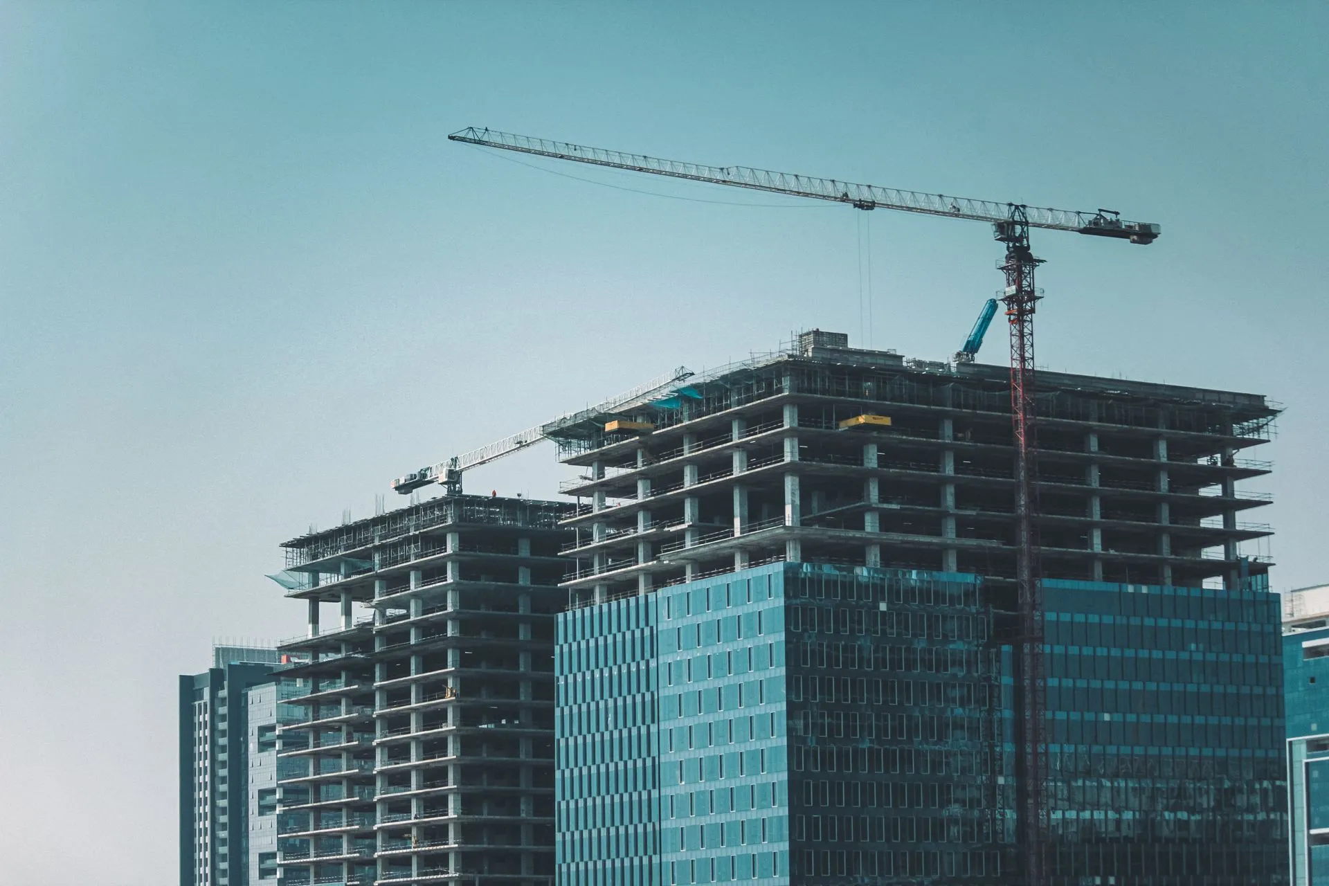 Tower cranes over a high-rise frame under construction